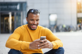 Hombre sonriente utilizando un smartphone