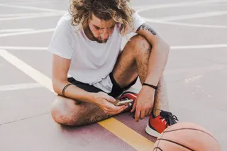 Hombre con unos tenis negros y rojos.
