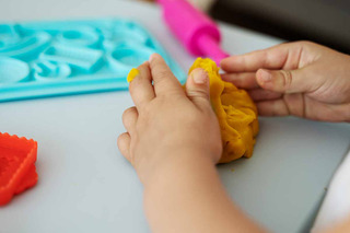 Manos de un niño moldeando plastilina 