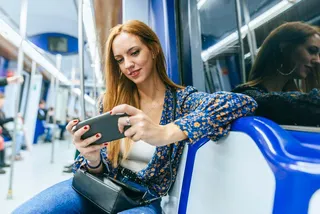 Mujer jugando videojuegos en su celular.