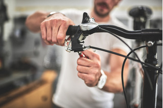 homem colocando freios em bicicleta