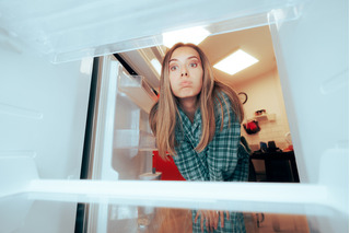 mujer buscando en la heladera