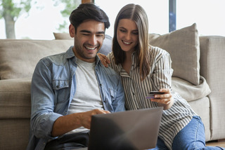 Una pareja hace compras en su notebook