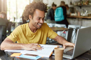 Homem usando notebook para estudar