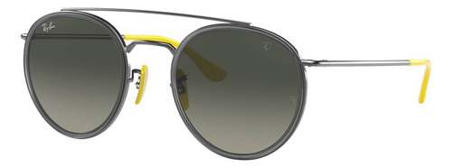 Anteojos de sol Ray-Ban Round Scuderia Ferrari Collection Standard con marco de metal color polished gunmetal, lente grey de plástico degradada, varilla polished gunmetal/yellow de metal - RB3647M