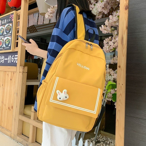 Mochila casual impermeable para mujer con adorno de color amarillo, diseño de tela lisa