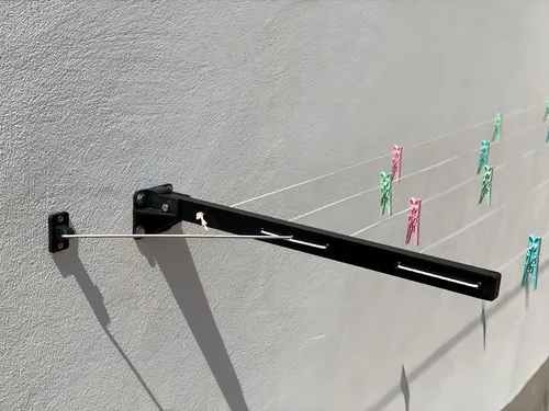 Tendedero de pared retráctil, plegable y articulado, negro