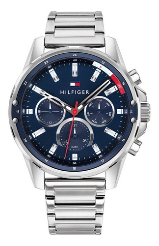 Reloj pulsera Tommy Hilfiger Mason 1791788 de cuerpo color plateado, analógico, para hombre, fondo azul, con correa de acero inoxidable color plateado, agujas color plateado y rojo, dial plateado, subesferas color azul y plateado, minutero/segundero blanco, bisel color azul y desplegable