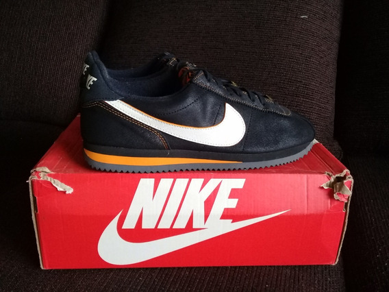 nike cortez negro y dorado