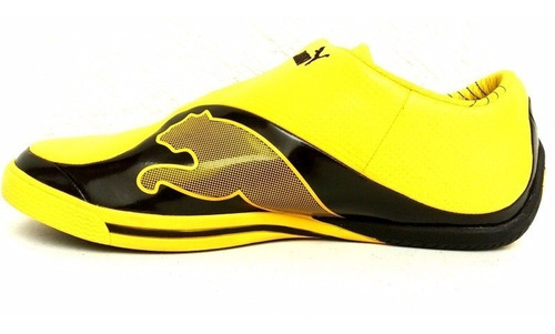 tenis puma negro con amarillo