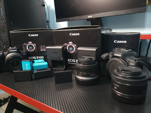 2 Canon R100, Lentes De Kit 18-45mm, Lente 50mm, Y Baterias Negro (Usado)