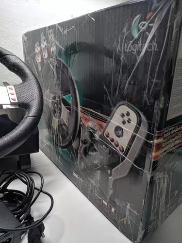 Lote 5373 - LOGITECH, VOLANTE GAMING - Modelo G27. Acessórios incluídos:  pedais, caixa de velocidades, fonte de alimentação e documentação. Volante  similar à venda por € 327. Nota: como novo, na caixa.