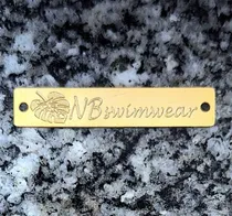 Comprar Dijes Identificadores De Marca Para Trajes De Baño, Y Otros