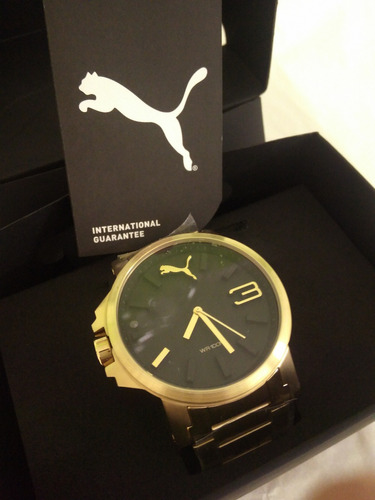 relógio puma ultrasize dourado