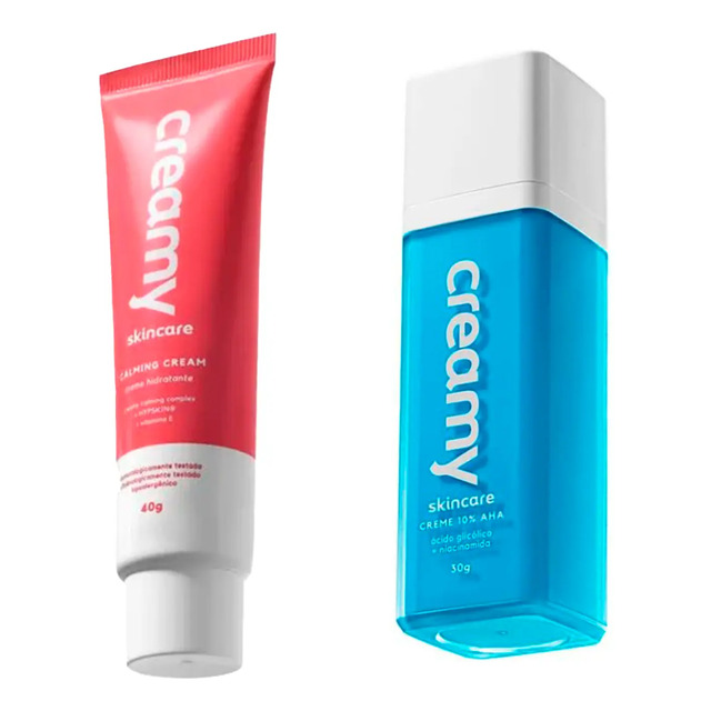 Kit de skincare da Creamy contendo um tubo de Calming Cream rosa de 40g e um frasco de Ácido Glicólico azul de 30g em fundo branco