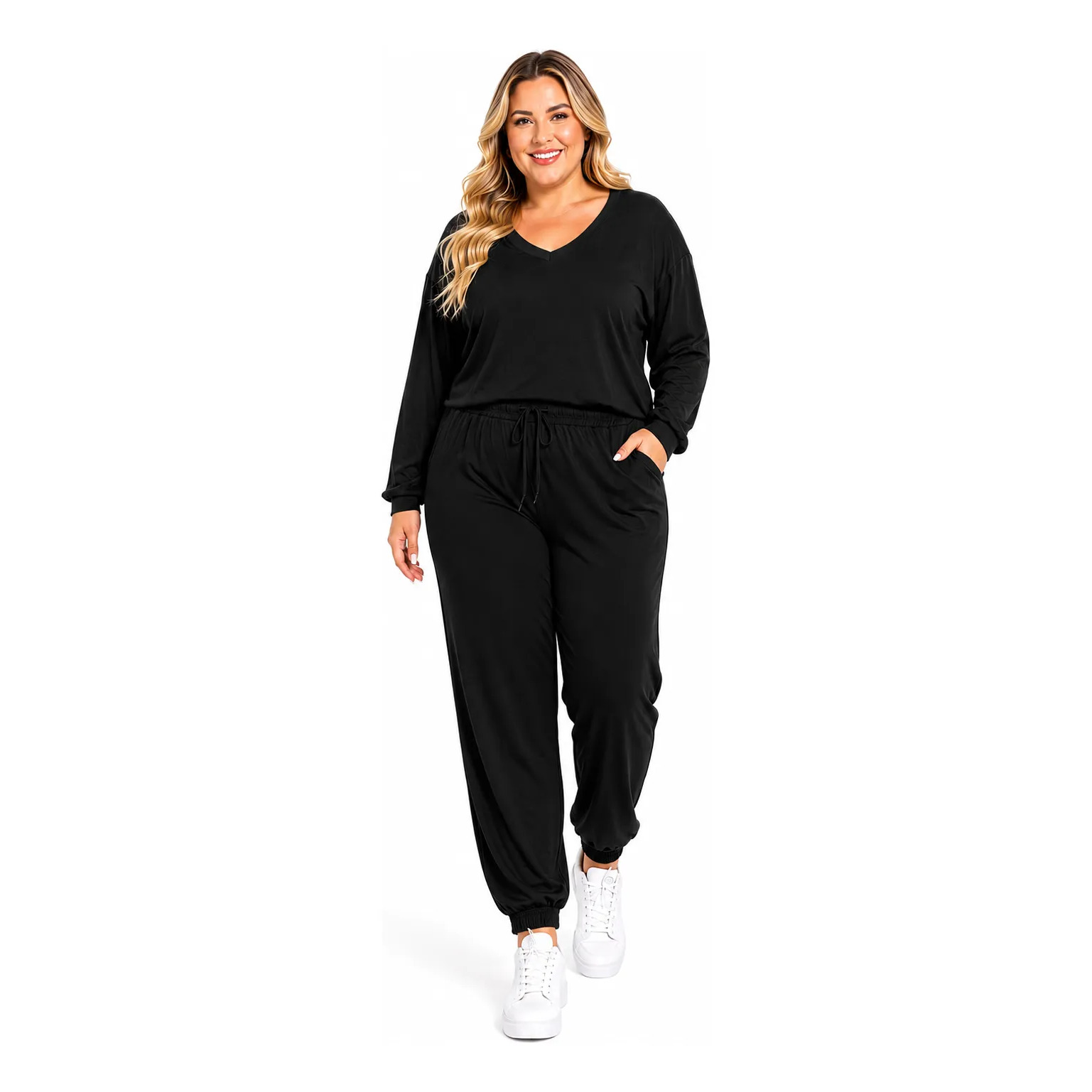 Modelo plus size vestindo conjunto de inverno preto composto por blusa de manga longa com gola V e calça jogger com bolsos e cordão na cintura, combinada com tênis brancos.