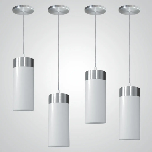 Quatro luminárias pendentes modelo copo da marca Utron, com cúpulas brancas e detalhes metálicos superiores, suspensas por cabos individuais em fundo cinza claro.
