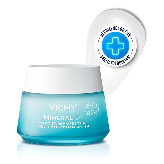Pote de vidro azul do hidratante facial Vichy Minéral 89 Sorbet com tampa branca, ao lado de um selo circular branco com a inscrição Recomendado por Dermatologistas e um ícone de cruz azul.