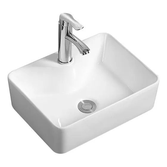 Lavabo De Baño De Cerámica Blanca Superpuesto, With A Elegant Inoxidable Steel Grifo. Es Adecuado Para Los Baños Modernos De Mediana Y Pequeña Dimensión De Las Viviendas Domésticas.