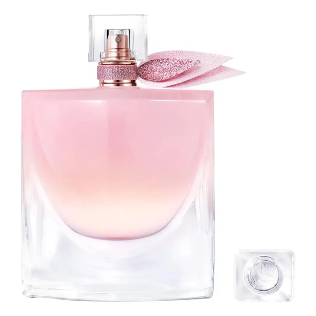Frasco de perfume Lancôme La Vie Est Belle Vanille Nude de 100ml com líquido rosado, tampa transparente e laço decorativo brilhante, acompanhado da tampa removida ao lado.