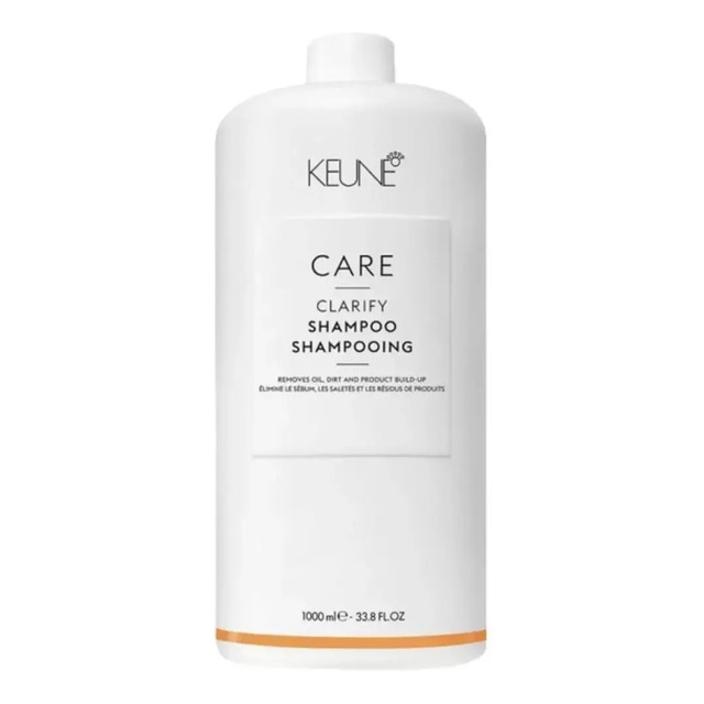 Frasco branco de 1000ml do shampoo Keune Care Clarify com rótulo minimalista e detalhes em laranja na base