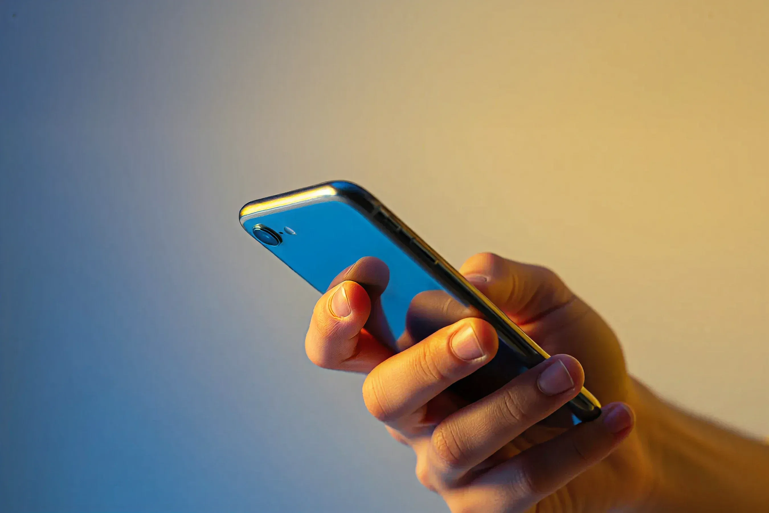 Primeiro plano de celular azul metálico ultrafino, destacando o design elegante onde opera o assistente de IA.
